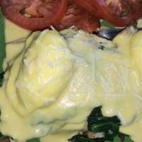 Florentine Eggs Benedict · Toasted baguette, sautéed spinach, poached eggs, hollandaise sauce topped with Parmesan chee...