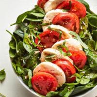 Caprese · The Caprese Salad: Fresh spinach served with fresh mozzarella, roma tomatoes, basil and garl...