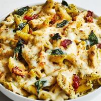 Nat Chicken Pesto  · The Nat: Penne pasta, with basil pesto, mozzarella and feta cheeses, topped with sun dried t...