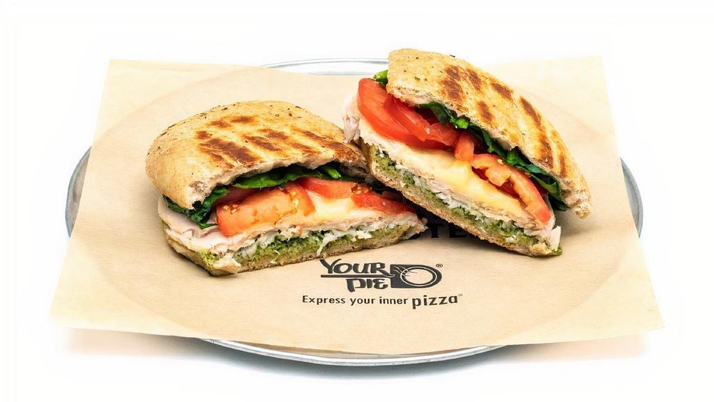 Pesto Turkey · The Pesto Turkey: Fresh basil pesto with spinach, roma tomatoes, and hand-carved turkey breast, topped with sliced provolone..