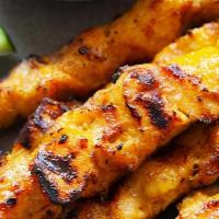 Chicken Satay · Grilled marinated chicken on skewers with peanut sauce and cucumber salad.