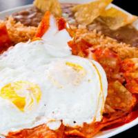 Chilaquiles With Eggs · Chilaquiles with your choice of sauce red or green and eggs, served with rice, beans.
