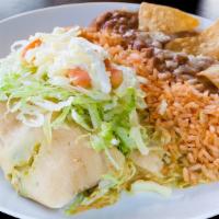 Ranchero Tamale Plate · Two tamales topped with lettuce, tomato, sour cream, and cheese with rice and beans.