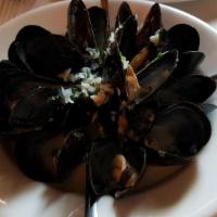 Moules Marinieres · Mussels cooked in white wine, butter, parsley, and shallots.