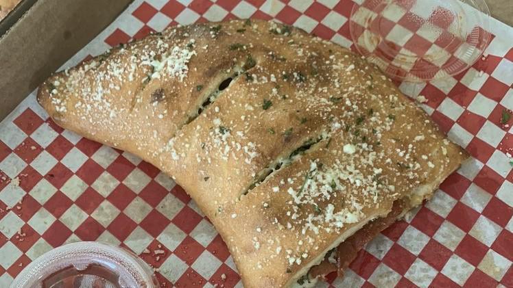 Calzones · Pizza Pocket stuffed with Ricotta cheese, Mozzarella cheese & choice of 2 Toppings (additional toppings $1.75 each).  Served with 2 sides of Marinara Sauce.