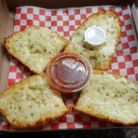 Cheese Bread · Order of garlic bread topped with mozzarella cheese and baked.
