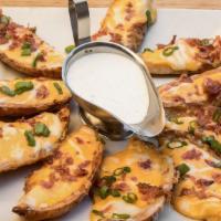 Potato Skins · Crispy potato skins topped with melted Monterey Jack and Cheddar cheeses, bacon bits, and sc...