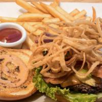 Hungry Hunter Burger · A juicy sirloin burger topped with cheese, bacon, onion strings, avocado, lettuce, tomatoes,...