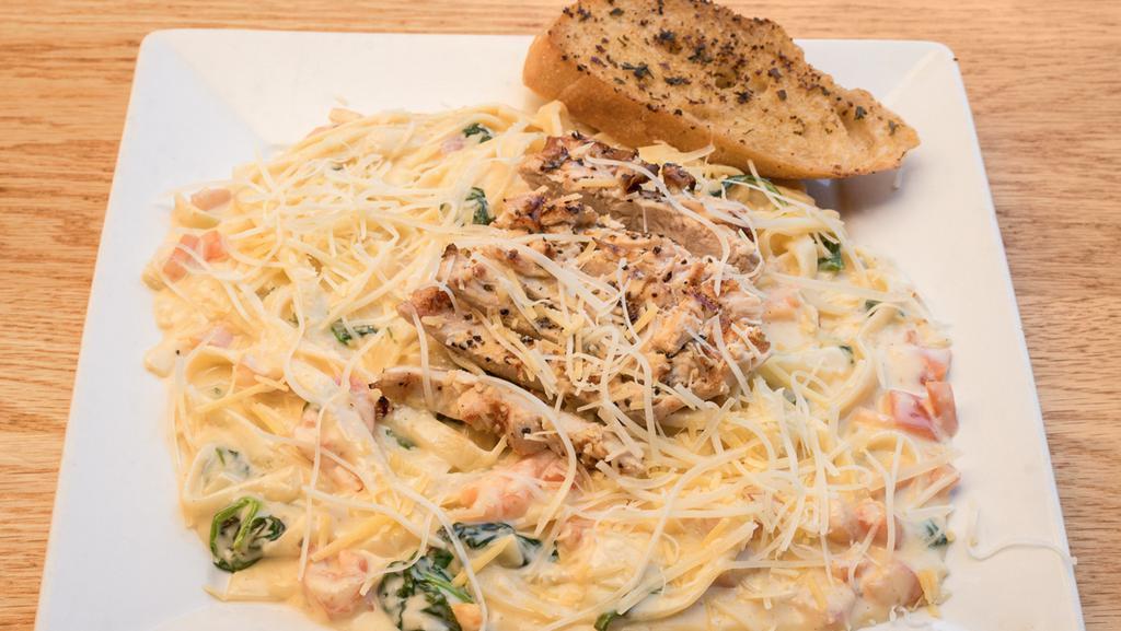 Traditional Fettuccine Alfredo · Fettuccine alfredo with diced tomatoes and spinach. Served with a garlic baguette. We pride ourselves on serving not only the finest beef, but outstanding seafood and pasta to match.