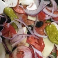 Greek Salad · Large bed of our mixed greens topped with kalamata olives, red and green bells, red onions, ...