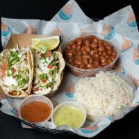 Cajun Grilled Shrimp Tacos · Two cajun grilled shrimp tacos served with a side of salsa, rice, and beans.