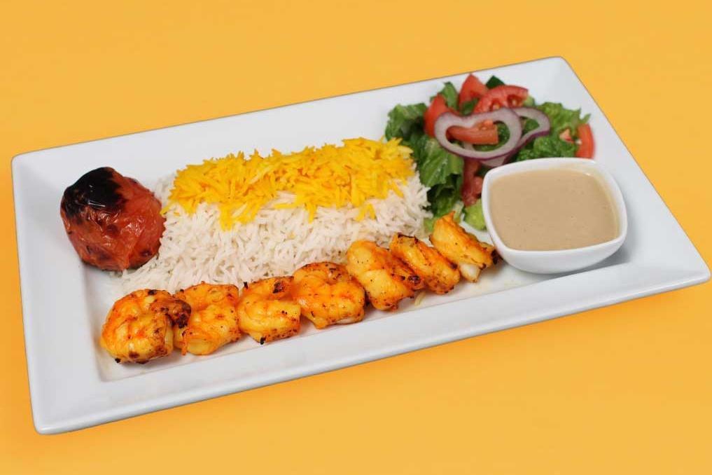 Shrimp Kebab Plate · One skewer of shrimp lightly marinated and charbroiled white rice with saffron, garden salad, pita bread, grilled tomato, and an additional side of your choice included in your order.