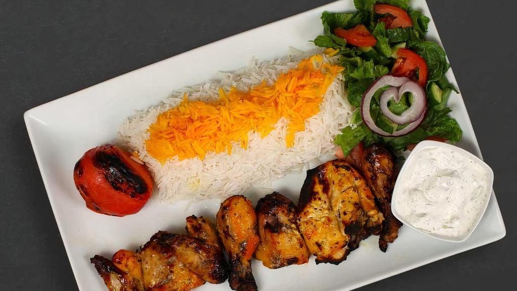 Cornish Hen Plate · Cornish game hen, one whole chicken per plate white rice with saffron, garden salad, pita bread, grilled tomato, and an additional side of your choice included in your order.