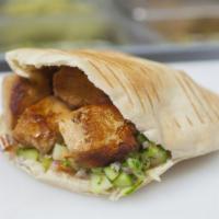 Chicken Wrap · One grilled chicken skewer wrapped in hummus, salad, pickles, tahini, tzatziki and hot sauce.