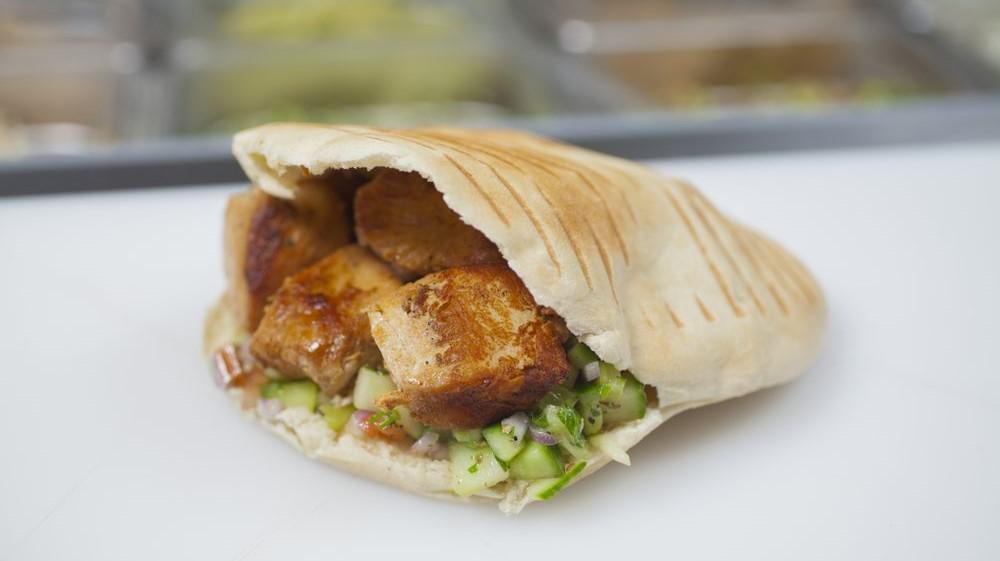 Chicken Wrap · One grilled chicken skewer wrapped in hummus, salad, pickles, tahini, tzatziki and hot sauce.