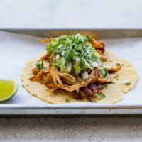 Shredded Chicken Taco** · Citrus marinated grilled chicken topped with diced onion, cilantro, guacamole and salsa verde