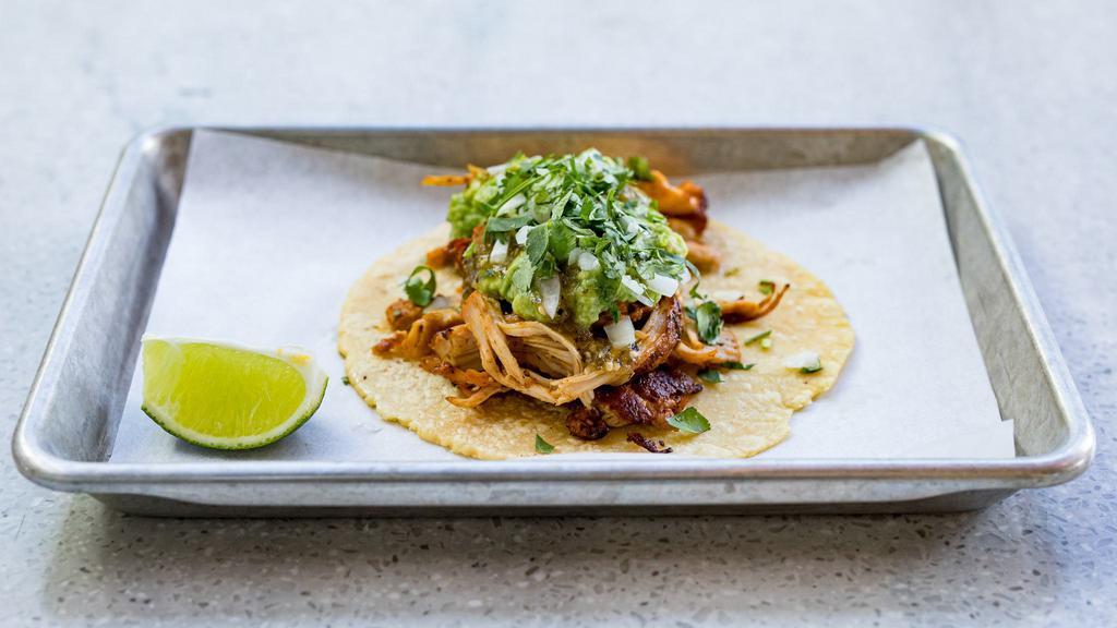 Shredded Chicken Taco** · Citrus marinated grilled chicken topped with diced onion, cilantro, guacamole and salsa verde