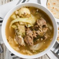 Sopa De Res Con Arroz · Beef soup with vegetables like yucca, chayote, cabbage & rice.