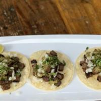 Carne Asada Tacos · Three street style tacos with carne asada, onions and cilantro.