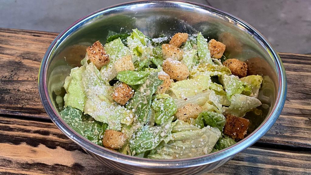 Caeser Salad Vegan · Chopped romaine lettuce, sourdough croutons, parmesan cheese, shredded carrots, Caesar dressing.