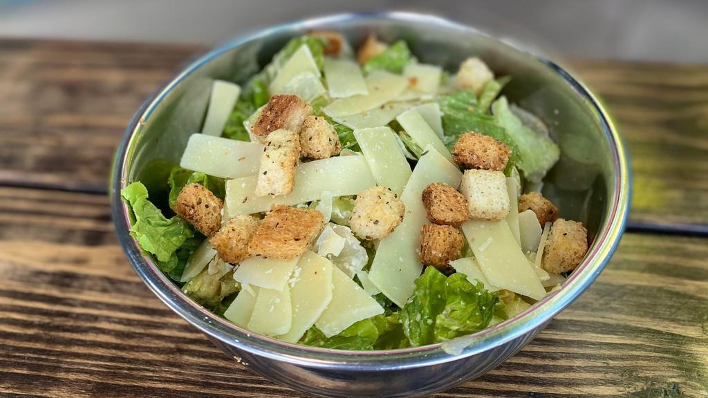 Caesar Salad · Chopped romaine lettuce, sourdough croutons, parmesan cheese, shredded carrots, Caesar dressing.