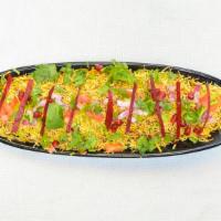 Bhel · A puffed rice, vegetables blended with tamarind chutney, green chutney and garlic chutney.