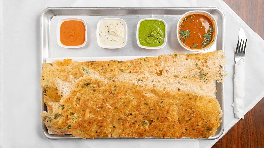 Rava Onion Dosa · Cracked wheat crepe with onions and spices. Served with sambar, white and garlic chutney