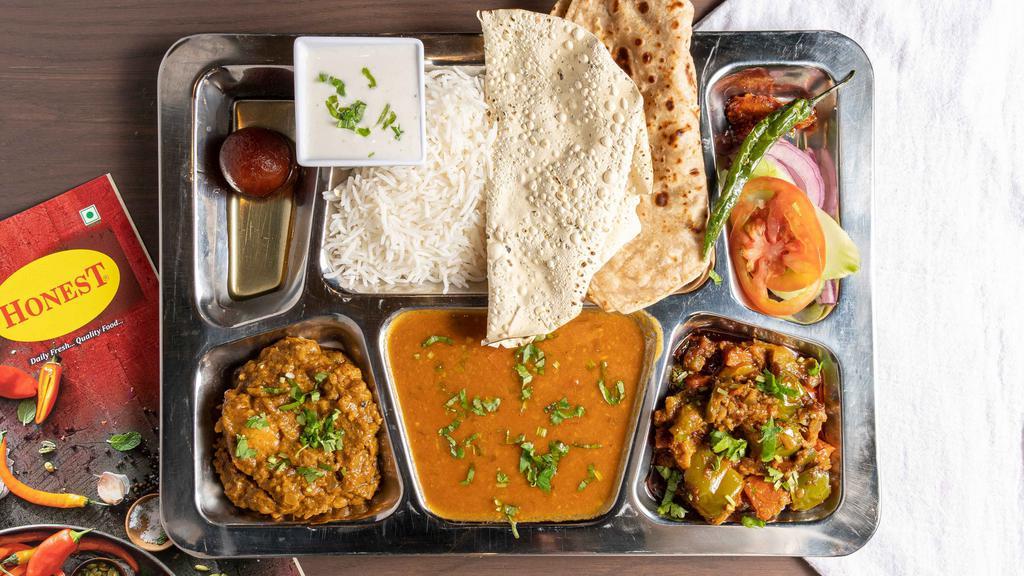Punjabi Thali · 2 Vegetables, 2 Roti, Dal, Rice, Yogurt, Salad, Pickle, Dessert.