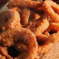 Onion Rings · 7 pieces of our House made coated & breaded Onion rings then fried to a golden brown
