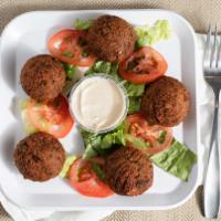 Falafel (5 Pieces) · Middle Eastern delight crispy falafel with tartar, tomatoes and lettuce in pita bread.