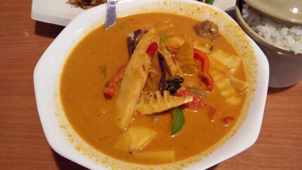 Red Curry · Spicy. Sliced meat in red curry paste with bamboo shoots, eggplant, green bean, bell pepper, and Thai basil in coconut milk.