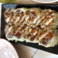 Crunchy Roll · Inside, shrimp tempura, imitation crab, avocado. Outside, eel sauce, crunchy flakes.