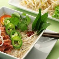 Rare Steak Pho · Rare steak in beef broth garnished with onion, scallion, cilantro, and a side of bean sprout...