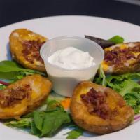 Potato Skins · Four potato skins topped with sour cream, melted jack and cheddar cheese with bacon bits.