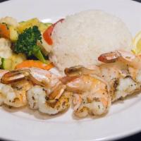 Grilled Jumbo Shrimp · Five jumbo shrimp grilled or Cajun style served with rice and seasoned sautéed vegetables.