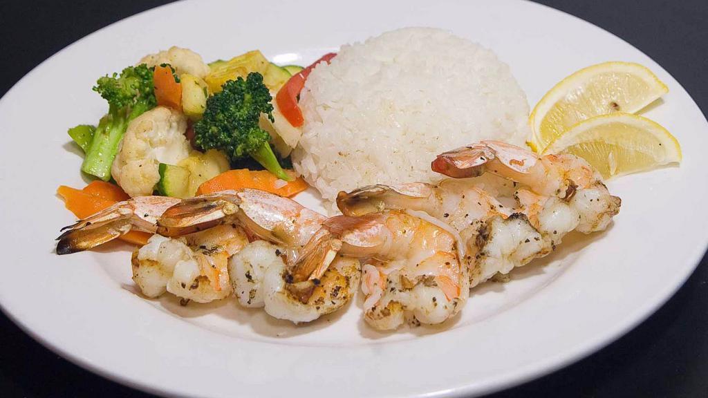 Grilled Jumbo Shrimp · Five jumbo shrimp grilled or Cajun style served with rice and seasoned sautéed vegetables.