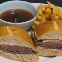French Dip Sandwich · Sliced rib-eye steak with melted Swiss cheese and mayo served on a baguette with a side of a...