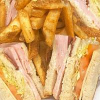 The Club Sandwich · Turkey, bacon, and Swiss cheese on toasted sourdough bread with mayonnaise, lettuce and toma...