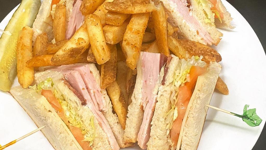 The Club Sandwich · Turkey, bacon, and Swiss cheese on toasted sourdough bread with mayonnaise, lettuce and tomato.