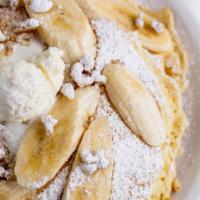 The Best Ever Banana Pancakes · Three buttermilk pancakes filled with a banana cinnamon puree topped with bananas, walnuts, ...