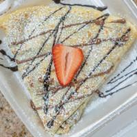 Strawberry Nutella Crepe · Crepe filled with fresh strawberry and Nutella drizzled with Nutella and powdered sugar.