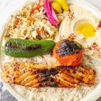 Salmon Kabab Plate · Marinated salmon served with hummus, rice, cabbage salad, pickles, garlic sauce, and pita br...