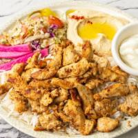 Chicken Shawarma Plate · Marinated chicken strips served with hummus, rice, cabbage salad, pickles, garlic sauce, and...