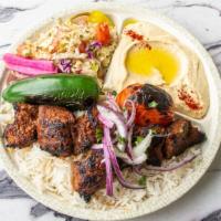 Beef Shish Kabab Plate · Marinated beef tender served with rice, red onions, roasted tomato, pepper, pickles, hummus,...