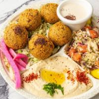 Falafel Plate · Vegan. Five pieces of falafel are served with hummus, tahini, lettuce, tomato, pickles, and ...