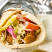 Falafel Wrap · Vegan. Served with falafel pieces wrapped in pita bread with lettuce, tomatoes, and tahini s...
