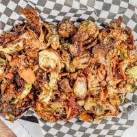 Crispy Brussels Sprouts · Brussels sprouts fried crispy with bacon and tossed in a sweet caramelized sugar glaze.