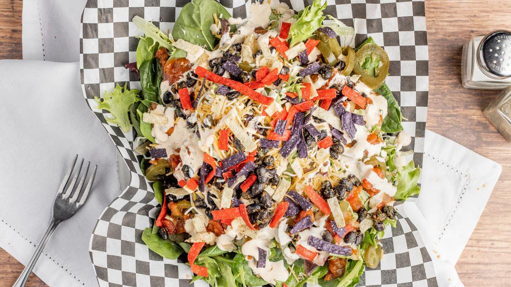Southwest Salad · Fresh mixed greens topped with seasoned black beans, cheddar cheese, salsa, tortilla strips and our house cilantro lime dressing.