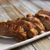 Baby Back Ribs · Baby Back pork ribs marinated in your house special BBQ Sauce