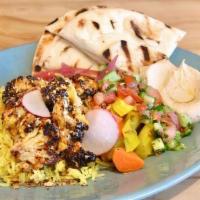 Shawarma Cauliflower Plate · Saffron Rice, Hummus, Naan, Israeli Salad, Schug, Pickled Vegetables, and Duqqa